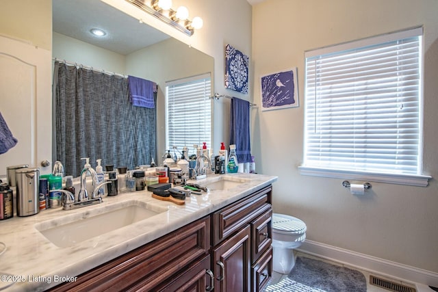 full bath with toilet, double vanity, baseboards, and a shower with shower curtain