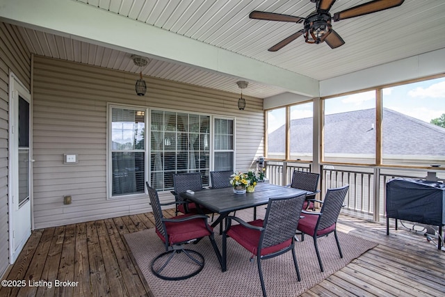 sunroom / solarium featuring ceiling fan, outdoor dining area, and beamed ceiling
