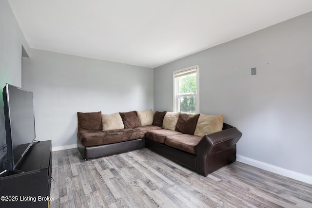 living area featuring light wood-style floors and baseboards