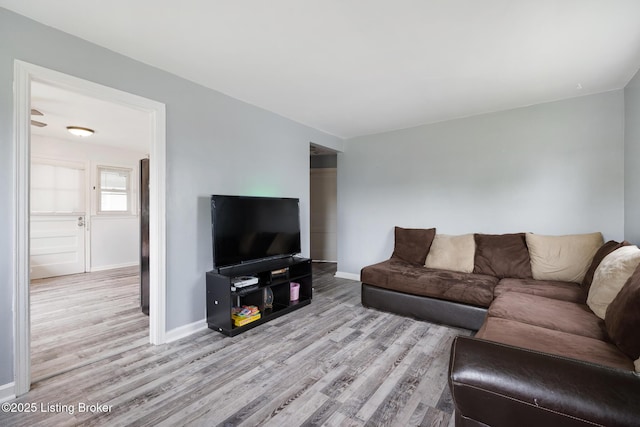 living area with wood finished floors and baseboards