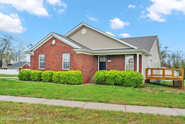 510 University Dr, Radcliff, KY 40160 - view of front facade featuring a front yard, brick siding, a deck, and roof with shingles