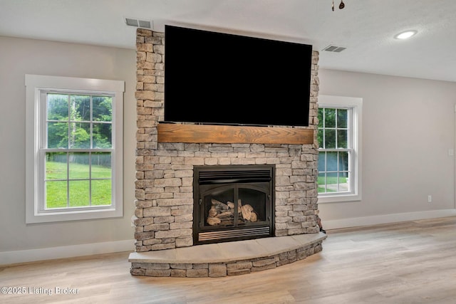 90 Glenn Eagle Rd, Brandenburg, KY 40108 - detailed view of wood finished floors, baseboards, a stone fireplace, and recessed lighting