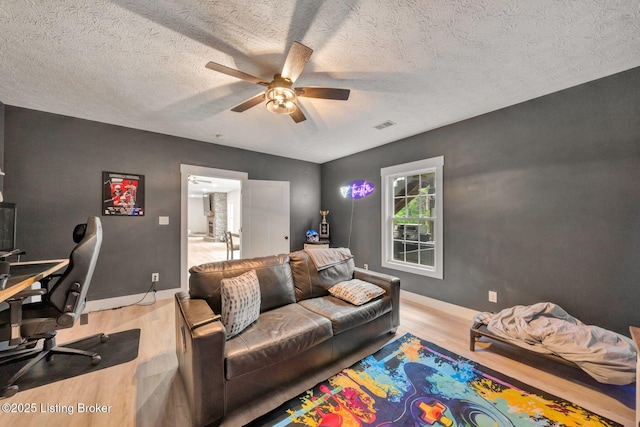 90 Glenn Eagle Rd, Brandenburg, KY 40108 - living area with light wood finished floors, a ceiling fan, a desk, a textured ceiling, and baseboards
