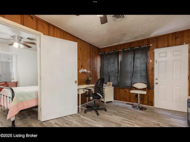 4328 S 1st St, Louisville, KY 40214 - home office with a ceiling fan, wood finished floors, and wooden walls