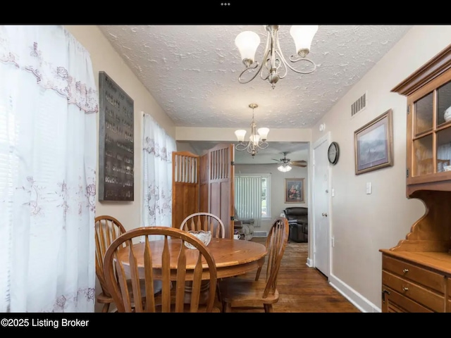 4328 S 1st St, Louisville, KY 40214 - dining space featuring a chandelier, a textured ceiling, dark wood-type flooring, baseboards, and ceiling fan