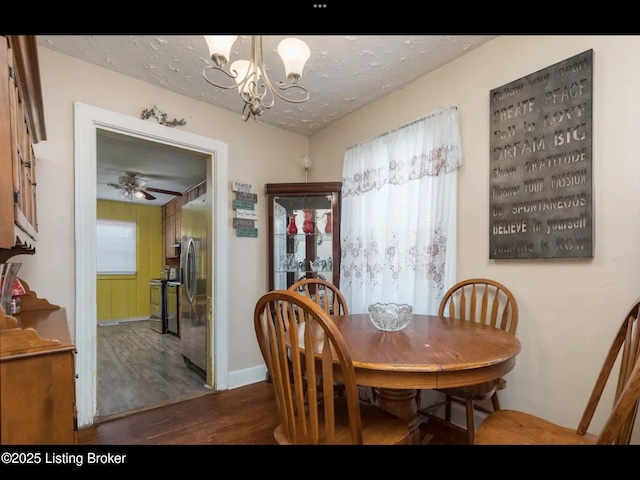 4328 S 1st St, Louisville, KY 40214 - dining room featuring wood finished floors, a chandelier, baseboards, and a textured ceiling