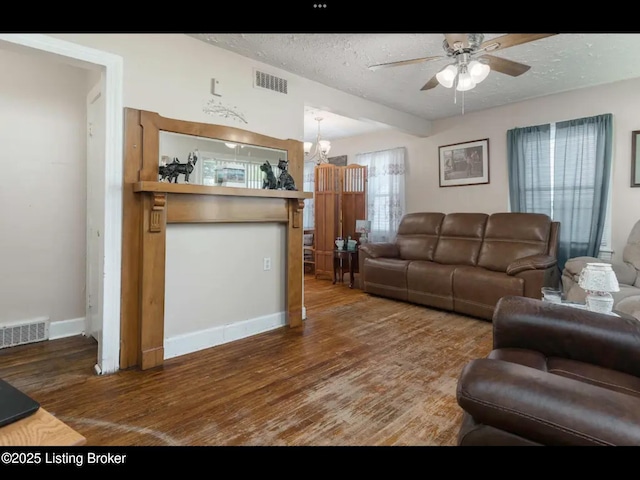 4328 S 1st St, Louisville, KY 40214 - living area with wood finished floors, ceiling fan, a textured ceiling, baseboards, and a chandelier