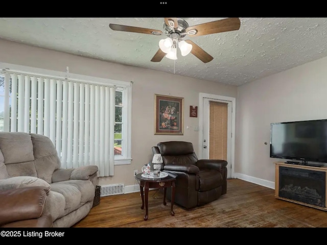 4328 S 1st St, Louisville, KY 40214 - living area featuring baseboards, wood finished floors, ceiling fan, and a textured ceiling