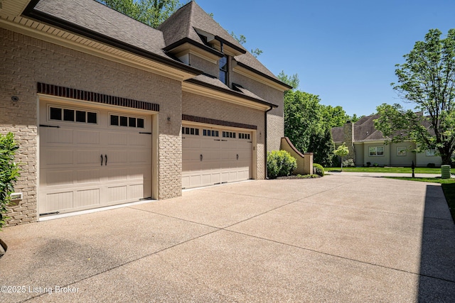 garage featuring concrete driveway