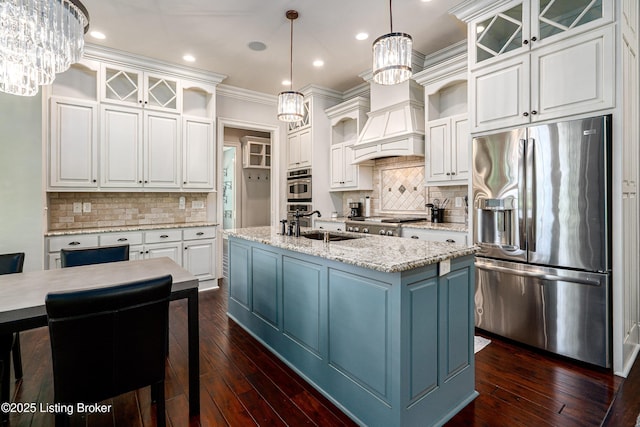 kitchen with appliances with stainless steel finishes, white cabinets, a sink, a chandelier, and dark wood-style flooring