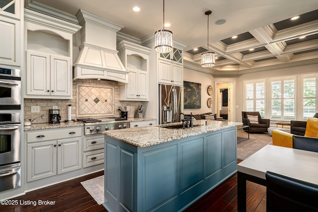 kitchen with stainless steel appliances, a warming drawer, a sink, dark wood finished floors, and open floor plan