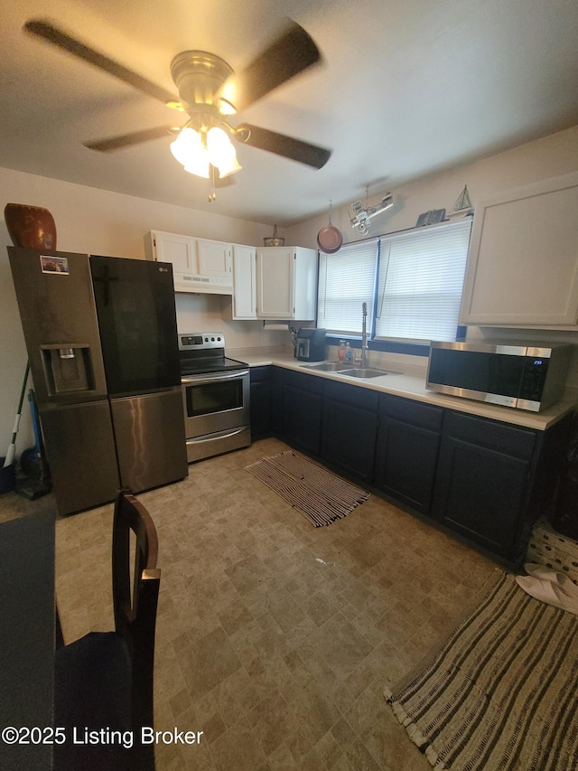 906 Kelly St, Carrollton, KY 41008 - kitchen featuring appliances with stainless steel finishes, a sink, ceiling fan, white cabinets, and light countertops
