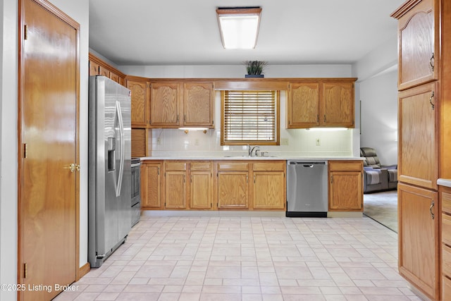 7601 Greenfield Ave, Louisville, KY 40214 - kitchen with appliances with stainless steel finishes, a sink, tasteful backsplash, and light countertops