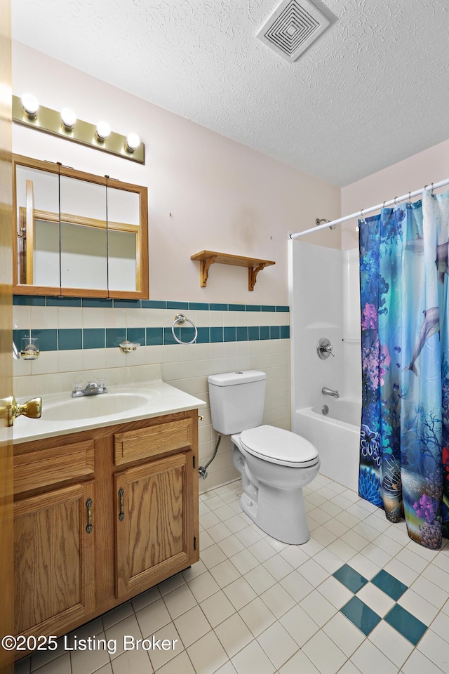 7601 Greenfield Ave, Louisville, KY 40214 - full bathroom with toilet, shower / tub combo with curtain, a wainscoted wall, a textured ceiling, and vanity