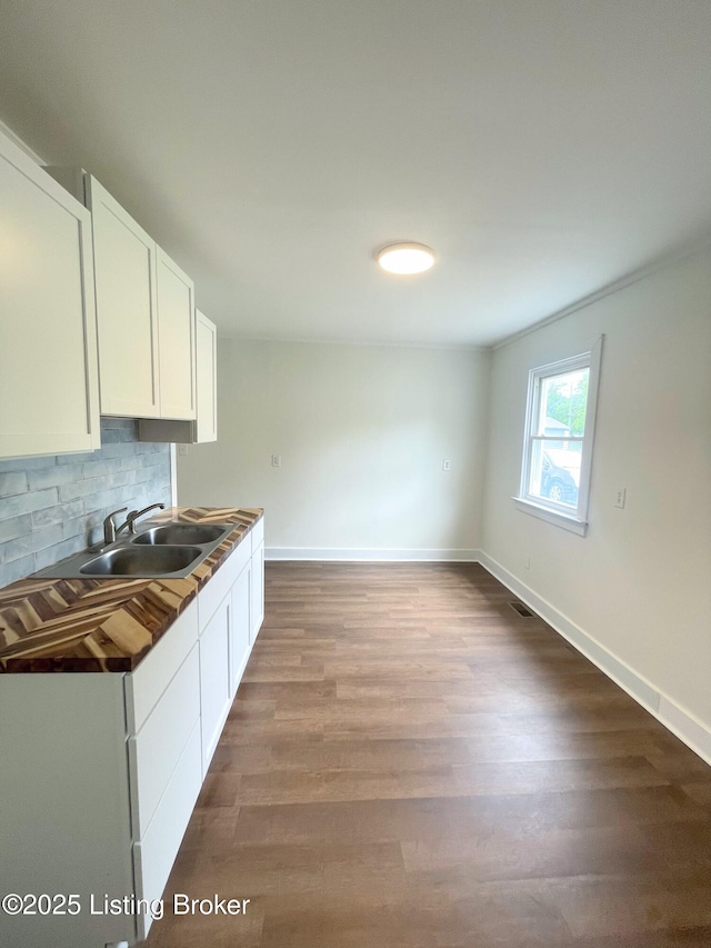 3004 Wayne Rd, Louisville, KY 40216 - kitchen featuring a sink, white cabinetry, backsplash, and baseboards