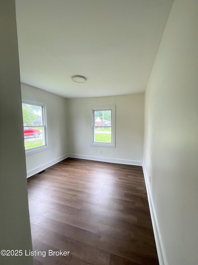 3004 Wayne Rd, Louisville, KY 40216 - empty room with dark wood-type flooring and baseboards