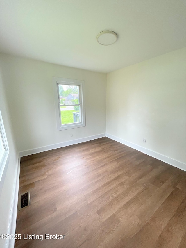 3004 Wayne Rd, Louisville, KY 40216 - spare room featuring dark wood-type flooring and baseboards