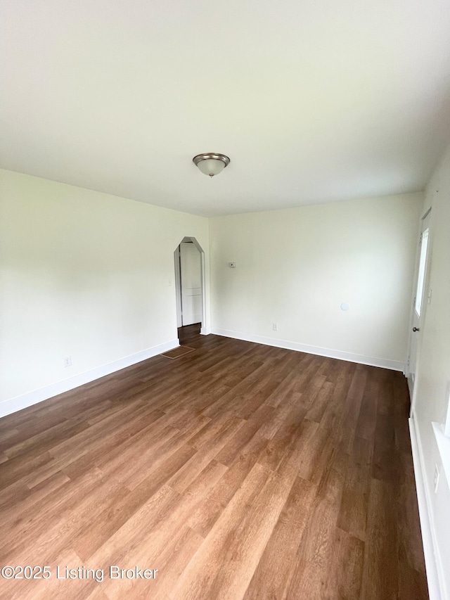 3004 Wayne Rd, Louisville, KY 40216 - unfurnished room featuring wood finished floors, arched walkways, and baseboards