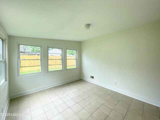 3004 Wayne Rd, Louisville, KY 40216 - spare room with light tile patterned floors, baseboards, and a textured ceiling
