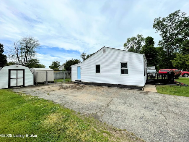 3004 Wayne Rd, Louisville, KY 40216 - back of property featuring an outdoor structure, a storage shed, and driveway