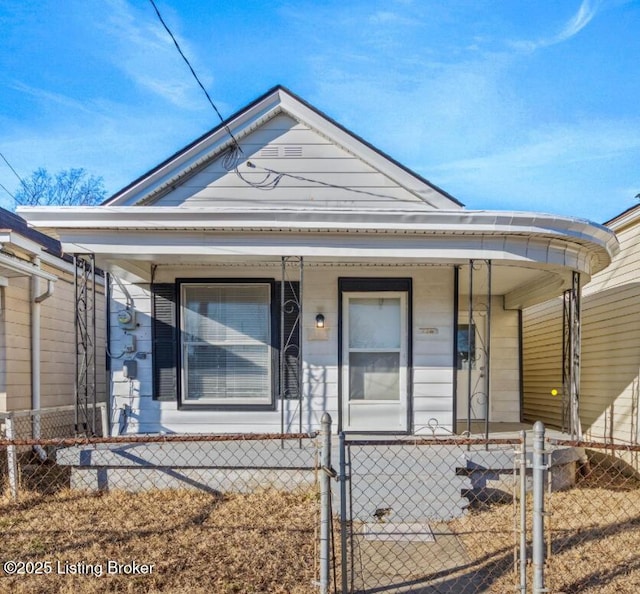 207 Ottawa Ave, Louisville, KY 40214 - shotgun-style home featuring a porch, a fenced front yard, and a gate