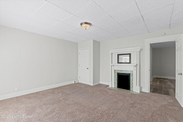 207 Ottawa Ave, Louisville, KY 40214 - unfurnished living room featuring carpet flooring, a tile fireplace, a paneled ceiling, and baseboards