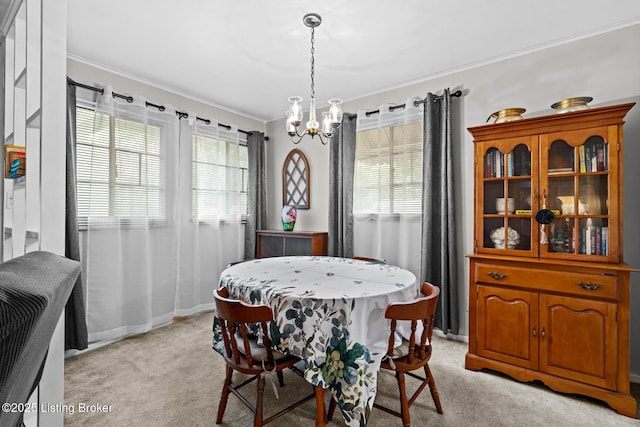 200 Derby Ave, Louisville, KY 40218 - dining room featuring ornamental molding, a chandelier, light carpet, and baseboards