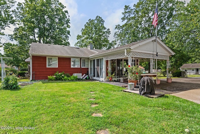 200 Derby Ave, Louisville, KY 40218 - rear view of property with a chimney, a yard, and a sunroom