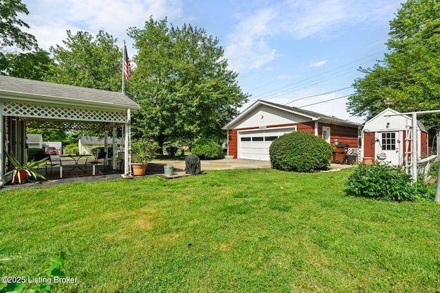 200 Derby Ave, Louisville, KY 40218 - view of grassy yard featuring an outdoor structure, a garage, and concrete driveway