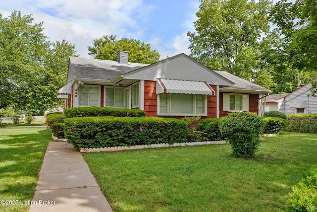 200 Derby Ave, Louisville, KY 40218 - bungalow with a chimney, a front lawn, and roof with shingles