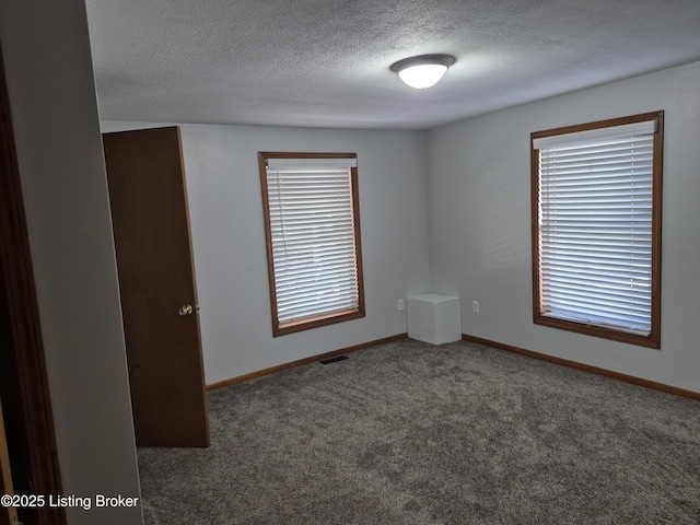 810 Packard Ave, Louisville, KY 40217 - carpeted empty room featuring a textured ceiling and baseboards