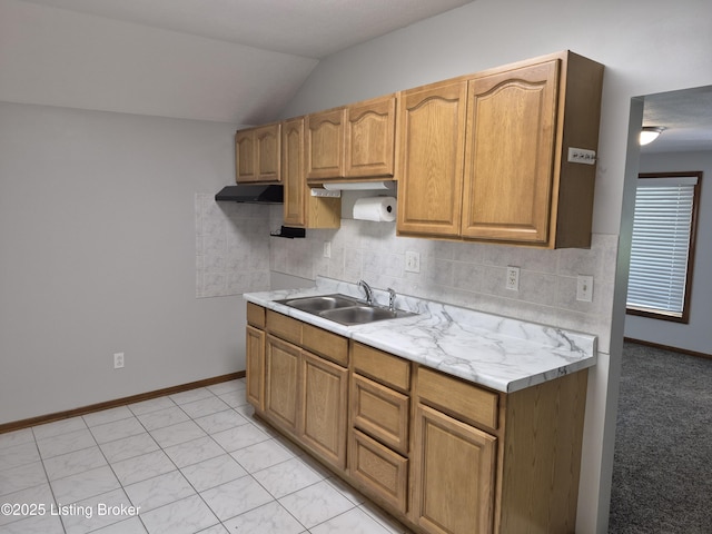 810 Packard Ave, Louisville, KY 40217 - kitchen featuring a sink, light countertops, vaulted ceiling, tasteful backsplash, and baseboards