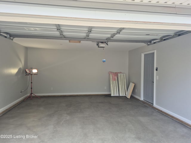 810 Packard Ave, Louisville, KY 40217 - garage with baseboards and a garage door opener