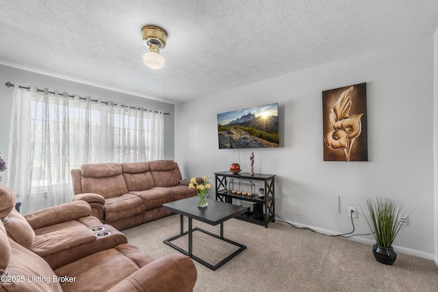 living room featuring light colored carpet and a textured ceiling