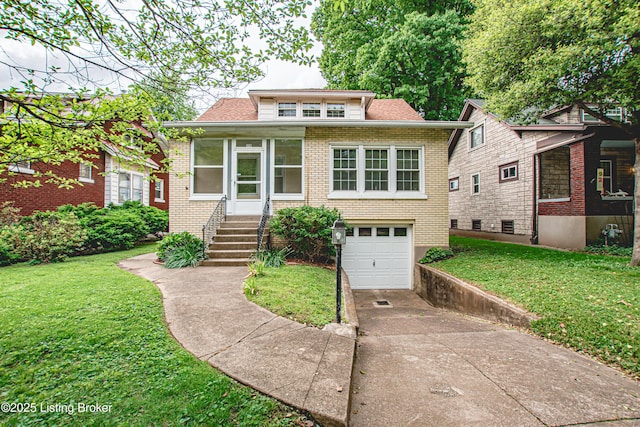 919 Eastern Pkwy, Louisville, KY 40217 - bungalow featuring concrete driveway, a front lawn, an attached garage, brick siding, and roof with shingles