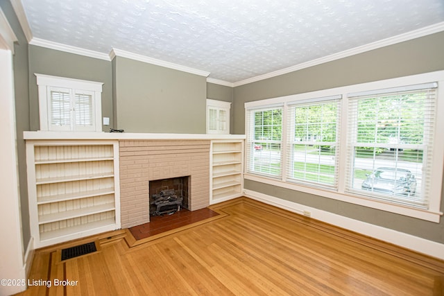 919 Eastern Pkwy, Louisville, KY 40217 - unfurnished living room with wood finished floors and a brick fireplace