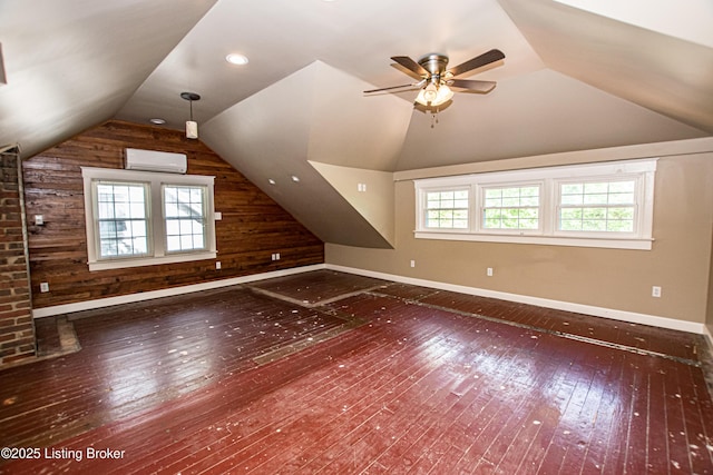 919 Eastern Pkwy, Louisville, KY 40217 - additional living space with an AC wall unit, wooden walls, hardwood / wood-style floors, vaulted ceiling, and baseboards