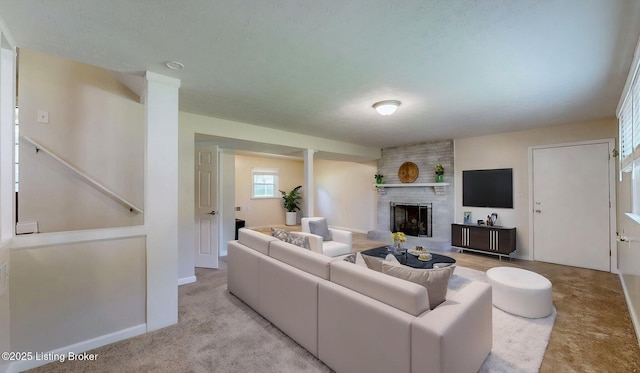 living area with a brick fireplace, light carpet, and baseboards