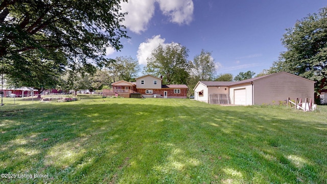 view of green lawn with an outbuilding and a garage
