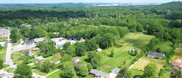 view of property location with a heavily wooded area