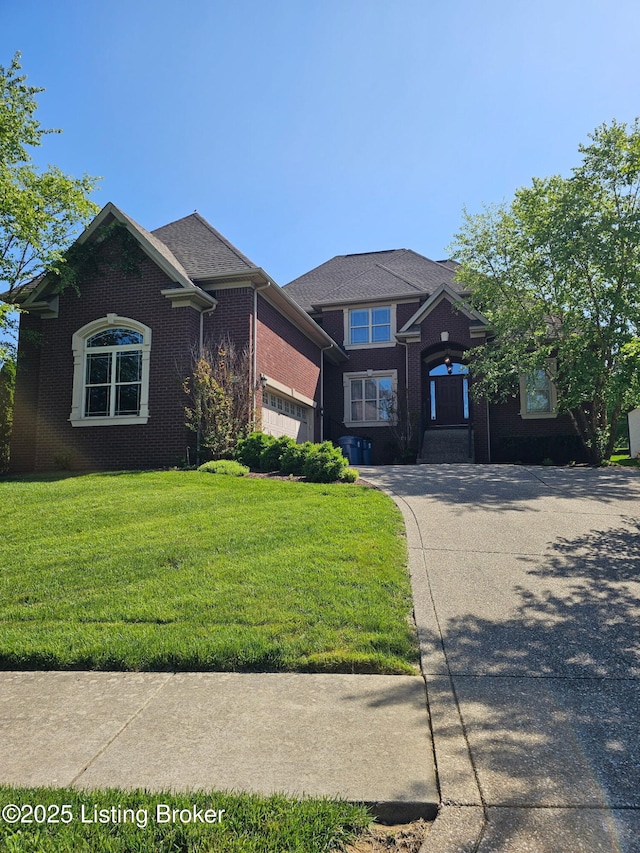 view of front facade featuring a front lawn, brick siding, and concrete driveway