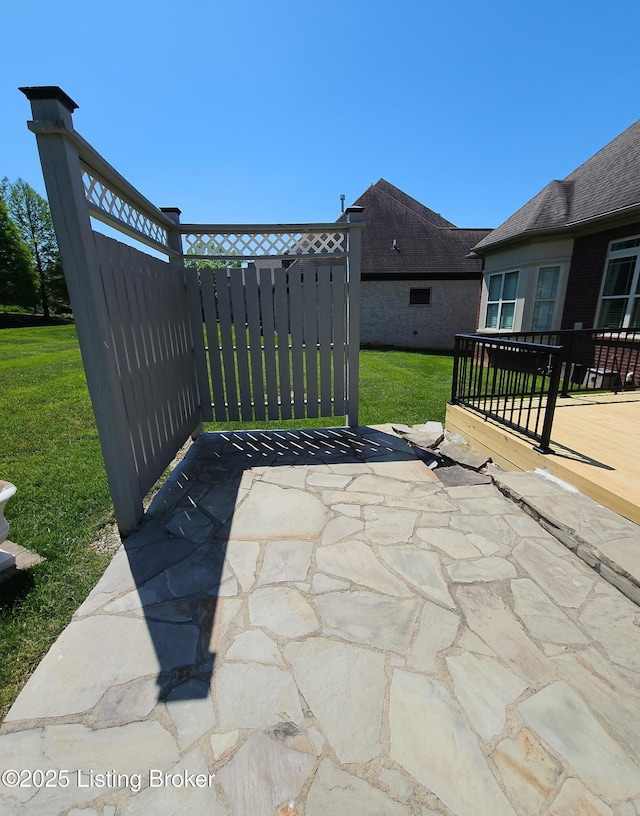 view of patio with a gate and a wooden deck