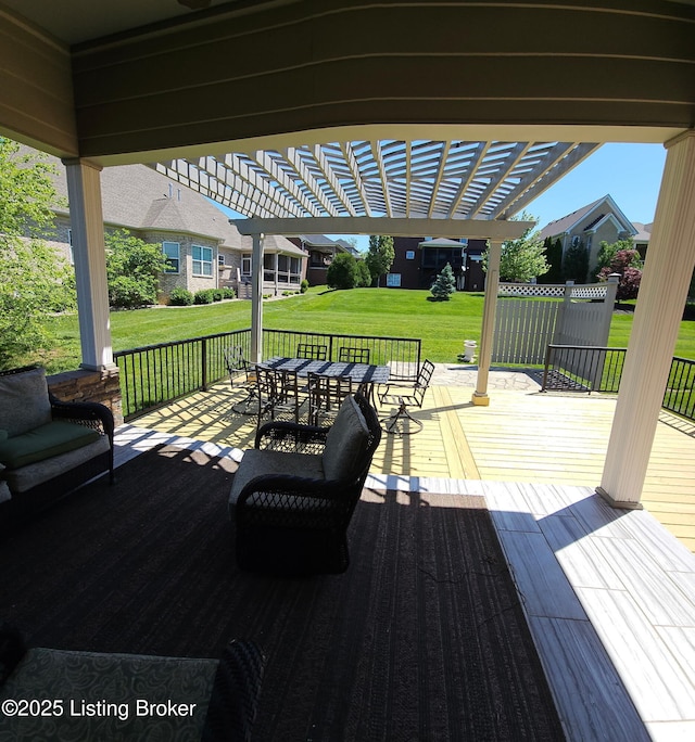 wooden deck featuring a pergola, outdoor dining space, and a yard