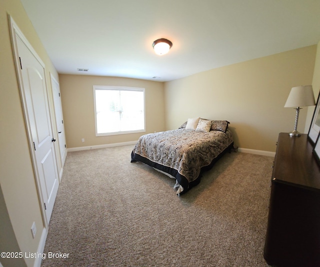 carpeted bedroom featuring baseboards