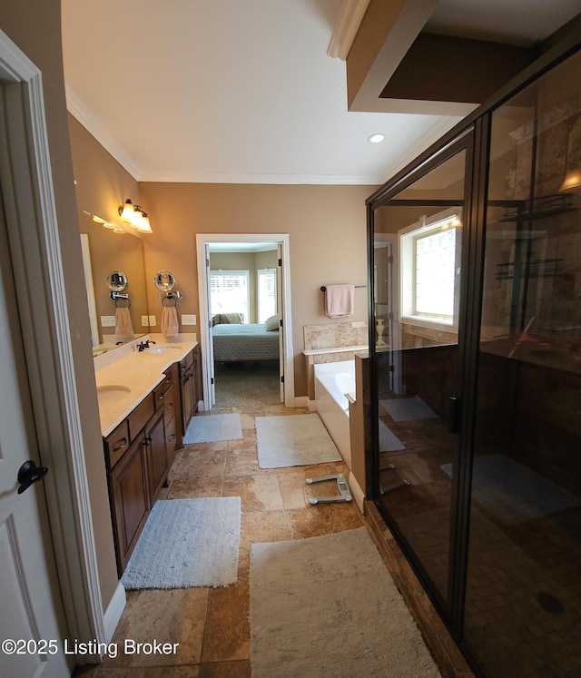 ensuite bathroom with ornamental molding, a bath, double vanity, a shower stall, and stone finish flooring