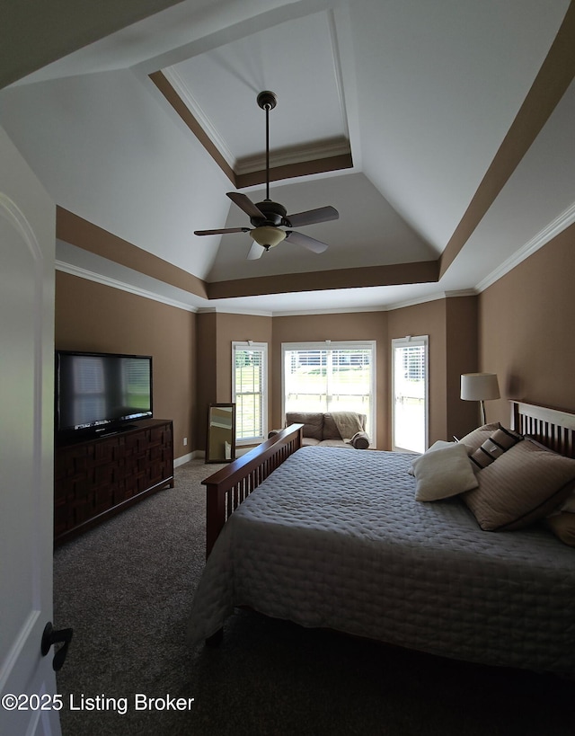 carpeted bedroom featuring a tray ceiling, ornamental molding, lofted ceiling, a ceiling fan, and baseboards