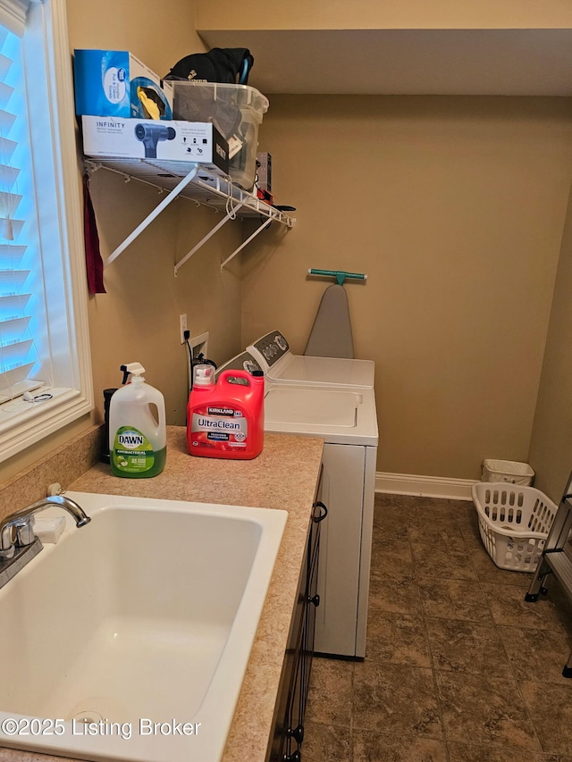 washroom featuring separate washer and dryer and cabinet space