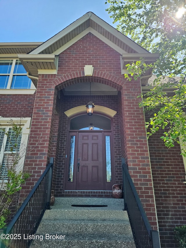 doorway to property with brick siding