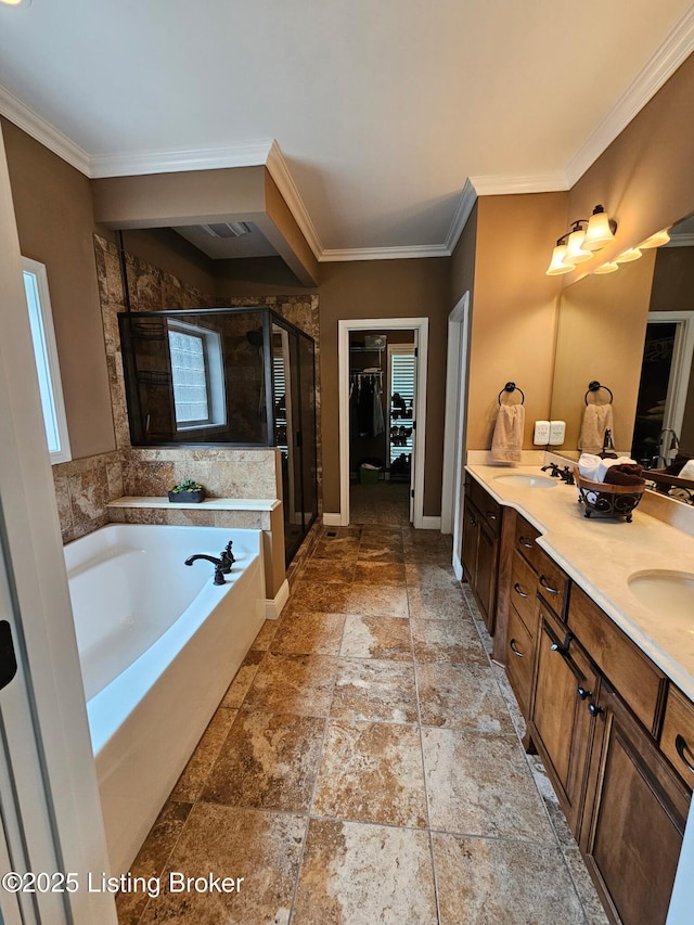905 Fossil Creek Cir, Louisville, KY 40245 - full bathroom featuring a shower stall, a garden tub, double vanity, ornamental molding, and stone tile flooring