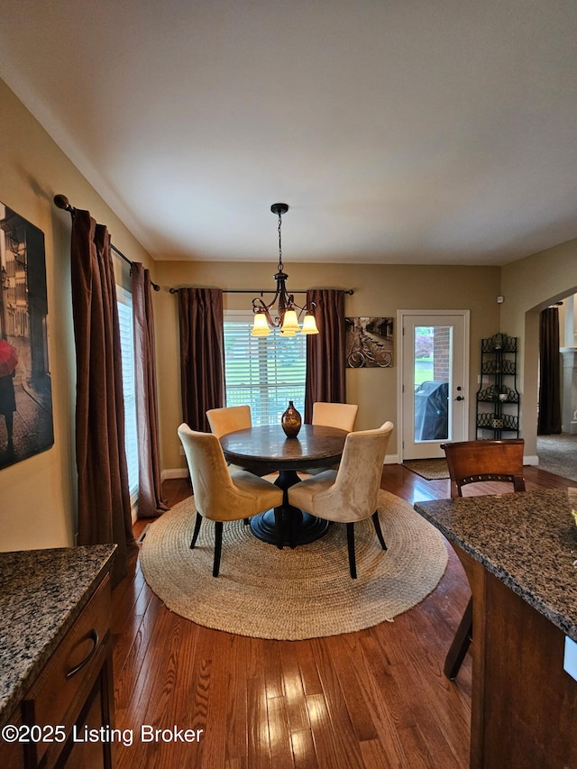 905 Fossil Creek Cir, Louisville, KY 40245 - dining space with dark wood-style flooring, a chandelier, healthy amount of natural light, and arched walkways